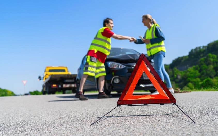 Útszéli segélyszolgálatos és ügyfél jól látható mellényben